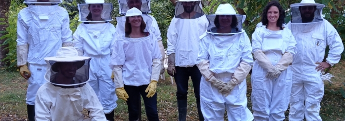 groupe de stagiaires en combinaison d'apiculteur